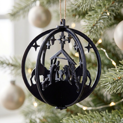 Dark blue Nativity ornament with neutral lighting on a Christmas tree