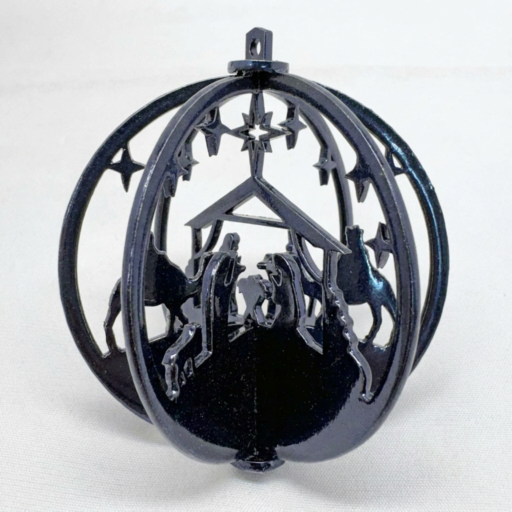 Dark blue 3D metal Nativity ornament with dimensional highlights and shadows