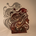 Swirling Santa metal candle luminary with its decorative Santa cast shadow
